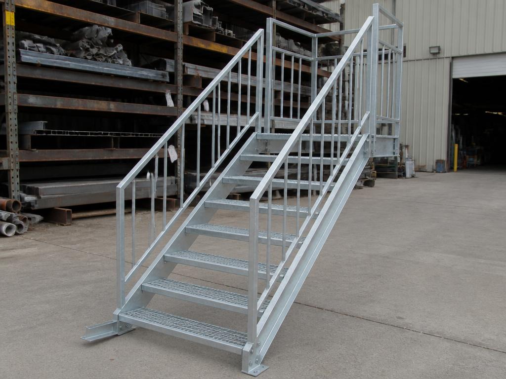 Industrial steel staircase with metal grating steps and galvanized finish